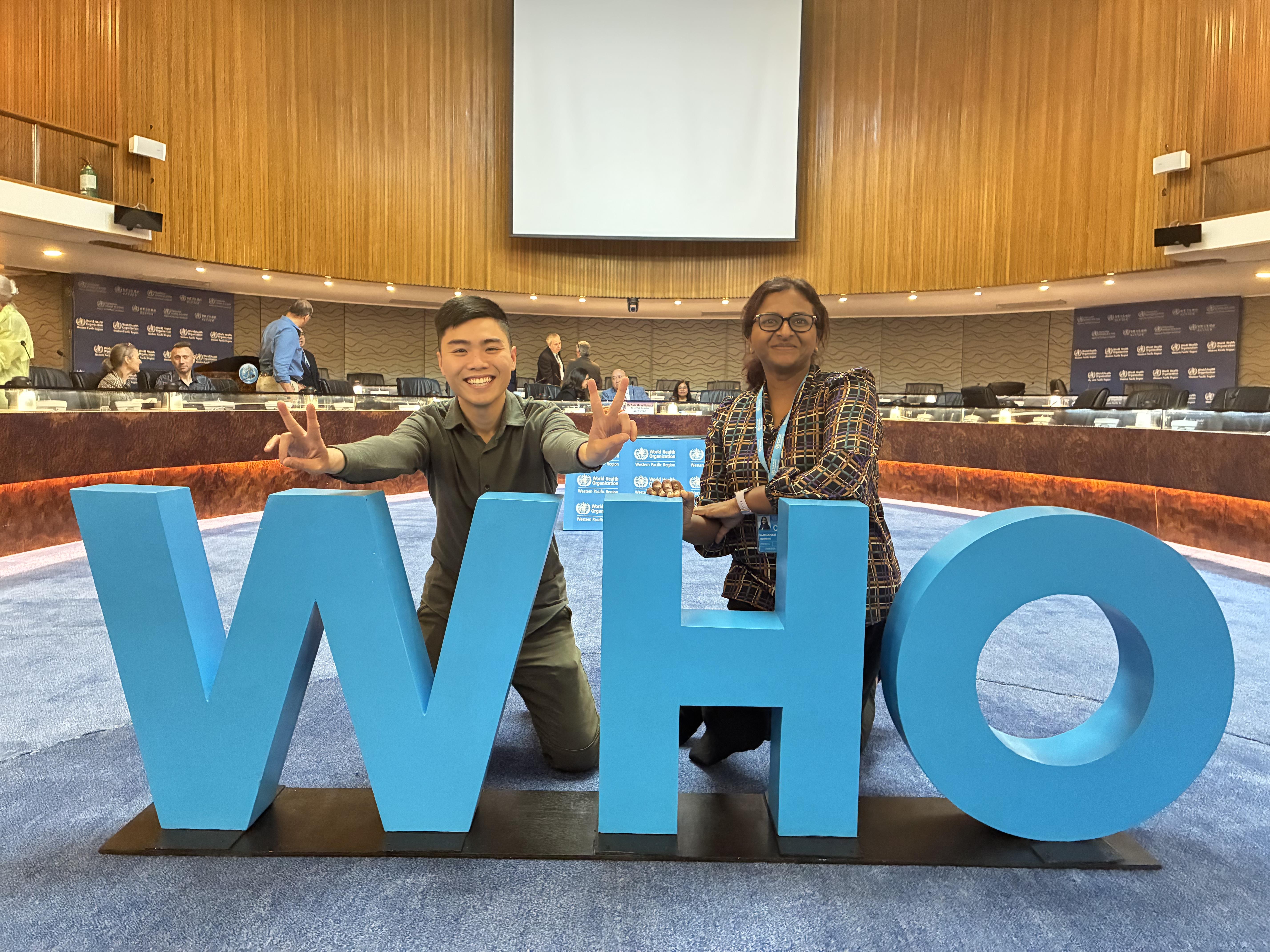 Fellows from WHO’s Field Epidemiology Fellowship Programme (FEFP) in the Western Pacific pose in front of WHO signage